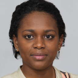 Joyful black young-adult female with short  brown hair and brown eyes