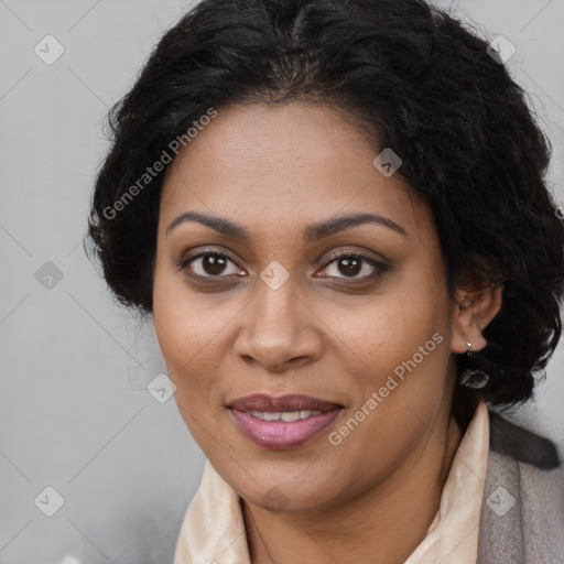 Joyful black adult female with long  brown hair and brown eyes