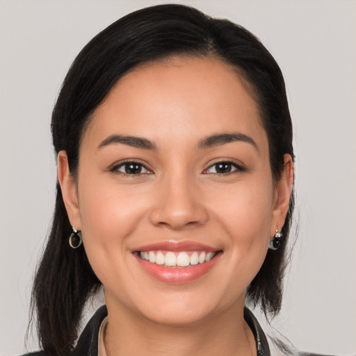 Joyful white young-adult female with long  brown hair and brown eyes