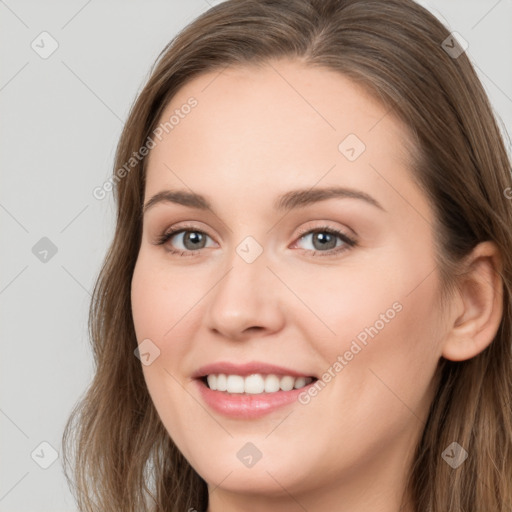 Joyful white young-adult female with long  brown hair and grey eyes