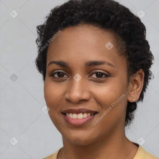 Joyful black young-adult female with short  black hair and brown eyes