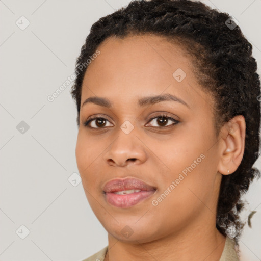 Joyful black young-adult female with long  brown hair and brown eyes