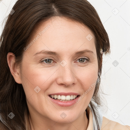 Joyful white adult female with medium  brown hair and grey eyes