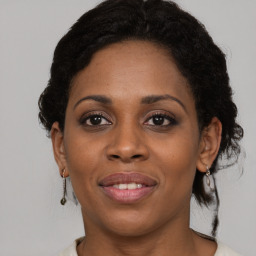 Joyful black young-adult female with medium  brown hair and brown eyes