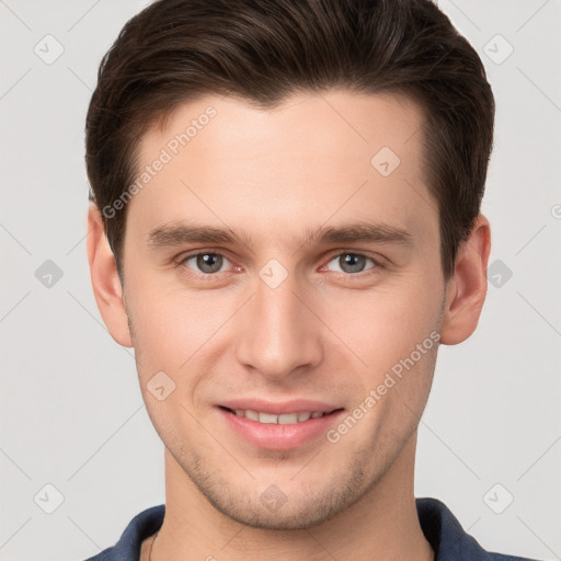 Joyful white young-adult male with short  brown hair and grey eyes