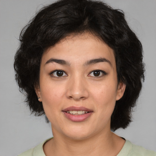 Joyful white young-adult female with medium  black hair and brown eyes