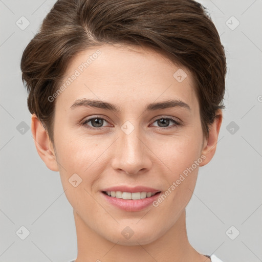 Joyful white young-adult female with short  brown hair and grey eyes