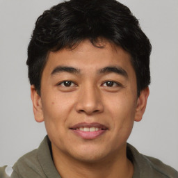 Joyful asian young-adult male with short  brown hair and brown eyes