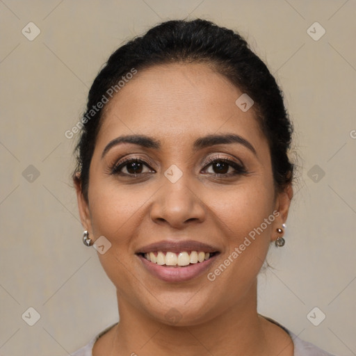 Joyful latino young-adult female with short  brown hair and brown eyes