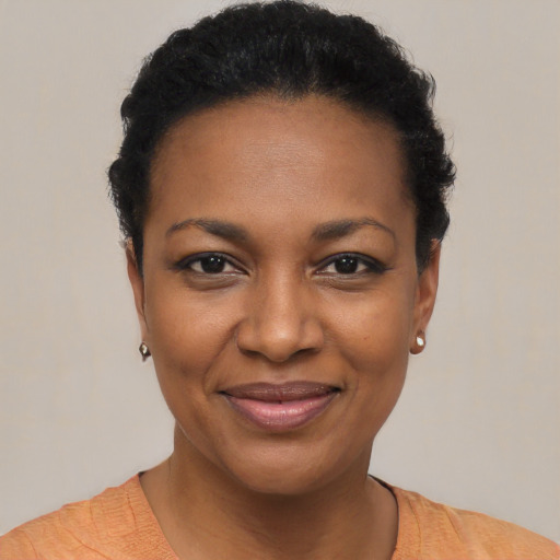 Joyful black young-adult female with short  black hair and brown eyes