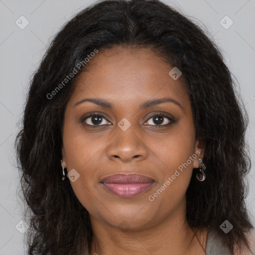 Joyful black young-adult female with long  brown hair and brown eyes