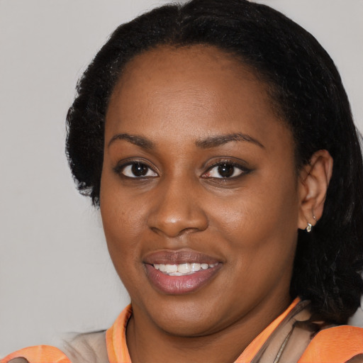 Joyful black young-adult female with medium  black hair and brown eyes