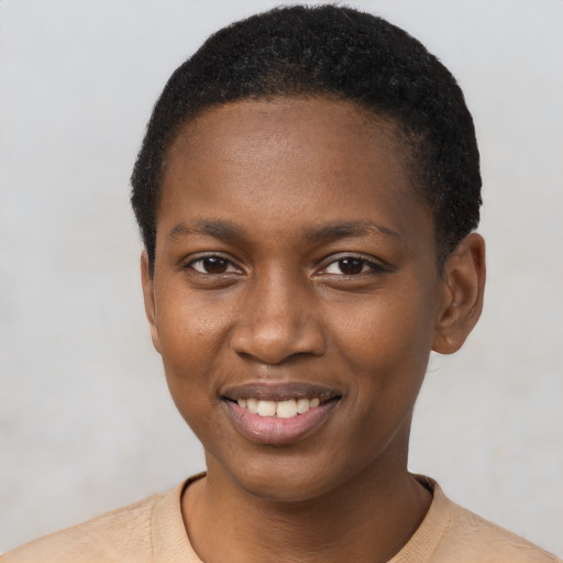 Joyful black young-adult female with short  black hair and brown eyes