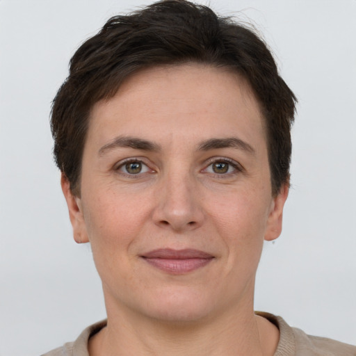 Joyful white adult female with short  brown hair and brown eyes