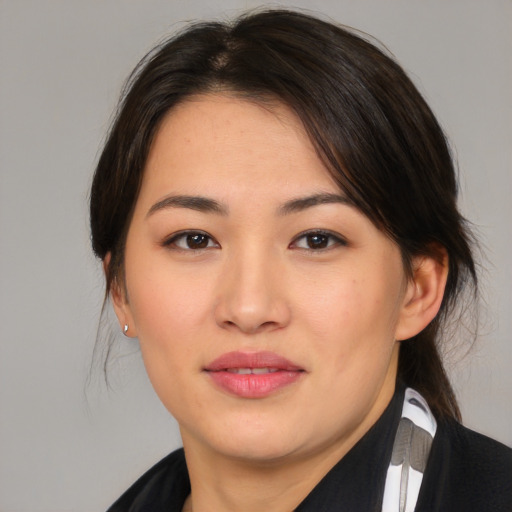 Joyful asian young-adult female with medium  brown hair and brown eyes