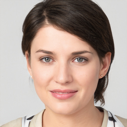 Joyful white young-adult female with medium  brown hair and grey eyes