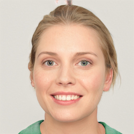 Joyful white young-adult female with medium  brown hair and green eyes