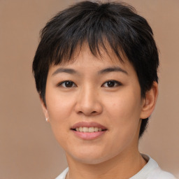 Joyful asian young-adult female with short  brown hair and brown eyes