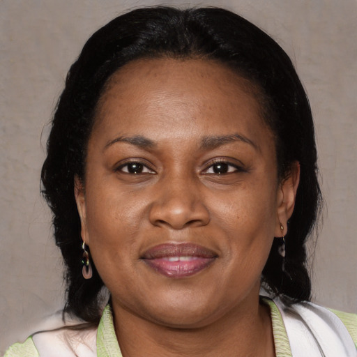 Joyful black adult female with medium  brown hair and brown eyes