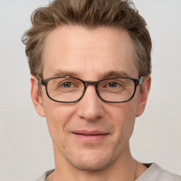 Joyful white adult male with short  brown hair and grey eyes