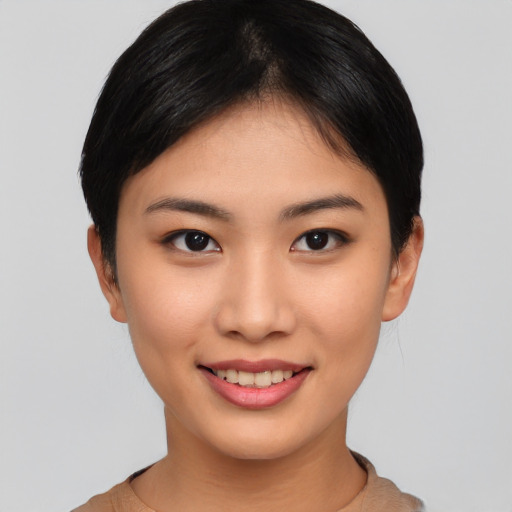 Joyful asian young-adult female with short  black hair and brown eyes