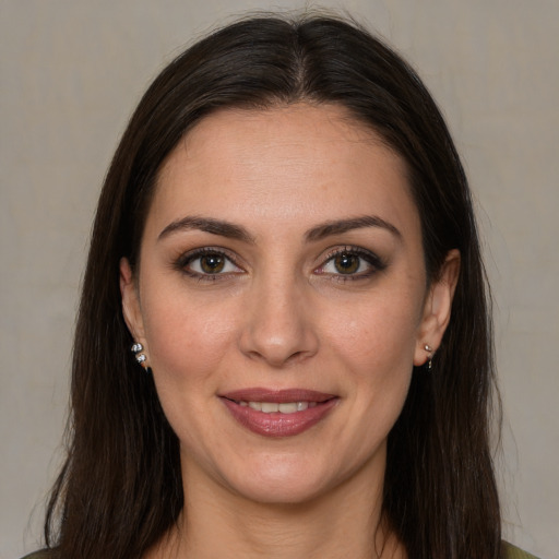 Joyful white young-adult female with long  brown hair and brown eyes