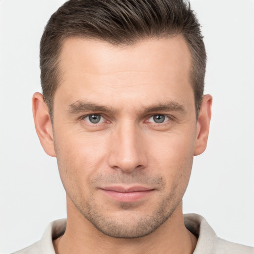 Joyful white young-adult male with short  brown hair and brown eyes