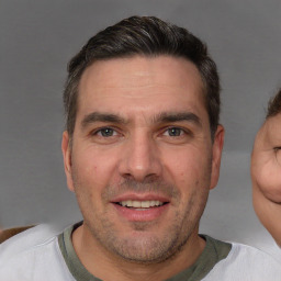 Joyful white adult male with short  brown hair and brown eyes