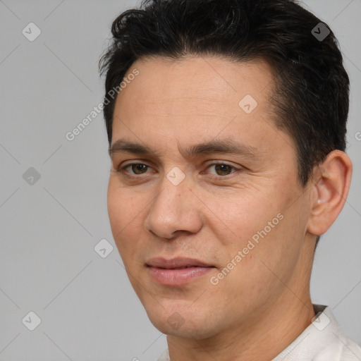 Joyful white adult male with short  brown hair and brown eyes