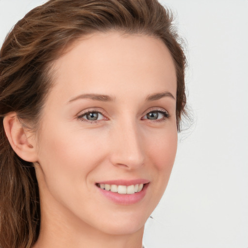 Joyful white young-adult female with long  brown hair and green eyes