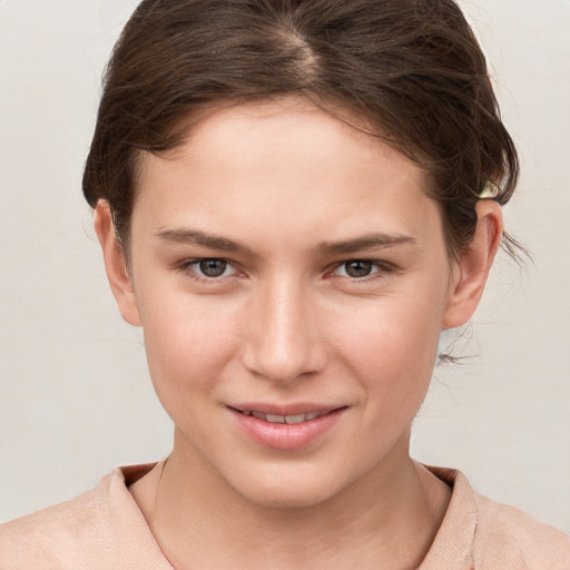 Joyful white young-adult female with short  brown hair and grey eyes