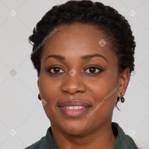 Joyful black young-adult female with short  brown hair and brown eyes