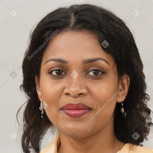 Joyful black adult female with medium  brown hair and brown eyes