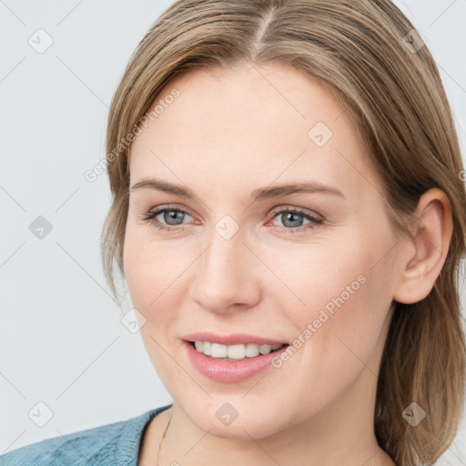 Joyful white young-adult female with medium  brown hair and blue eyes