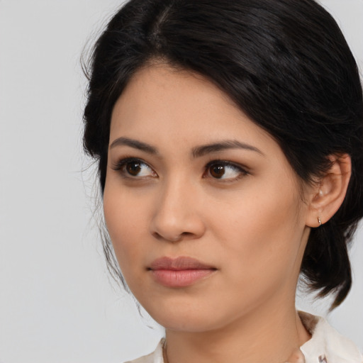 Joyful asian young-adult female with medium  black hair and brown eyes
