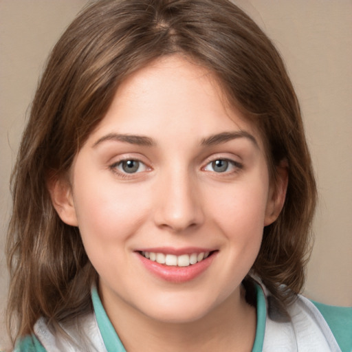 Joyful white young-adult female with medium  brown hair and green eyes