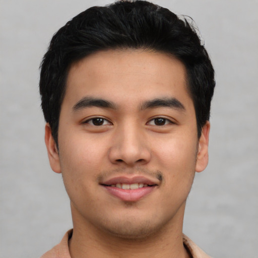 Joyful asian young-adult male with short  brown hair and brown eyes