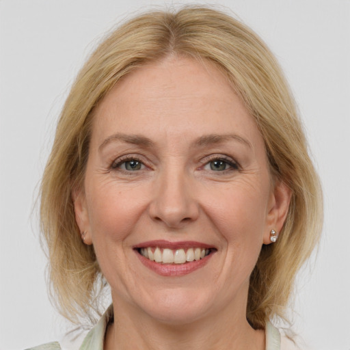 Joyful white adult female with medium  brown hair and grey eyes