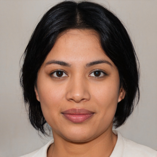Joyful latino young-adult female with medium  black hair and brown eyes