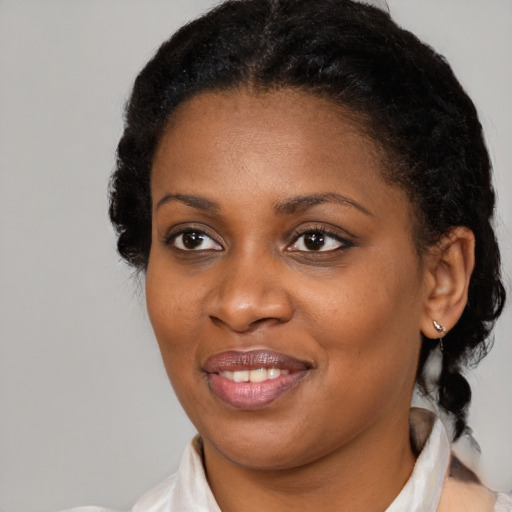 Joyful black young-adult female with medium  brown hair and brown eyes