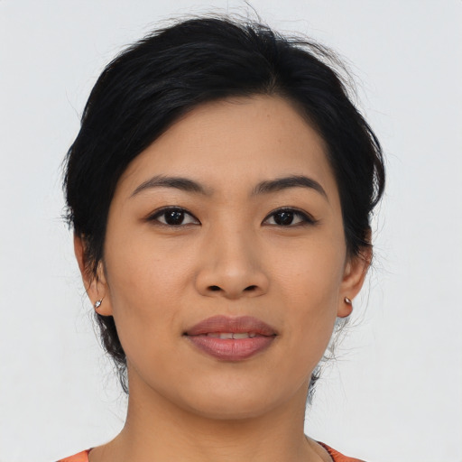 Joyful asian young-adult female with medium  black hair and brown eyes