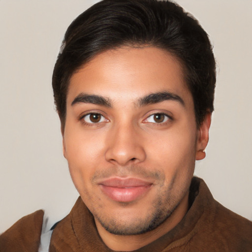 Joyful latino young-adult male with short  brown hair and brown eyes