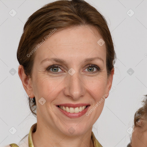 Joyful white adult female with medium  brown hair and grey eyes