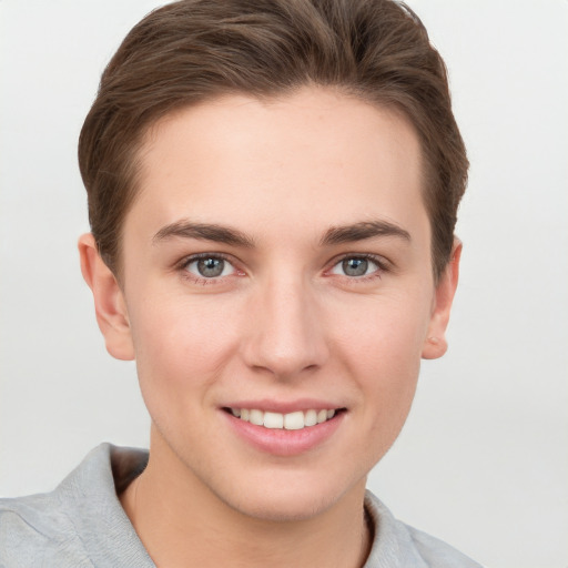 Joyful white young-adult female with short  brown hair and grey eyes