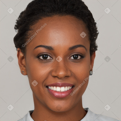 Joyful black young-adult female with short  black hair and brown eyes