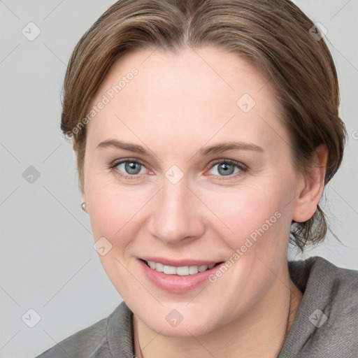 Joyful white young-adult female with long  brown hair and blue eyes