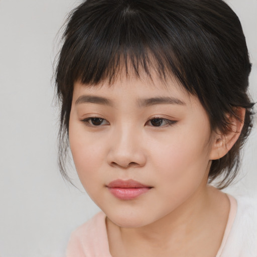 Joyful asian child female with medium  brown hair and brown eyes