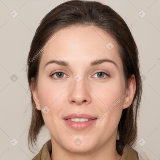 Joyful white young-adult female with medium  brown hair and grey eyes