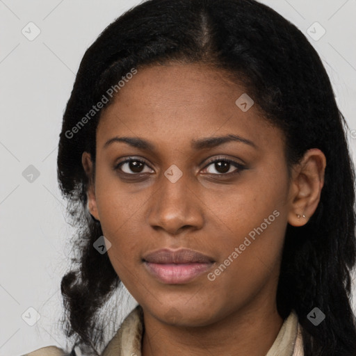 Joyful black young-adult female with long  black hair and brown eyes