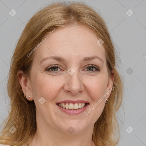 Joyful white adult female with medium  brown hair and blue eyes